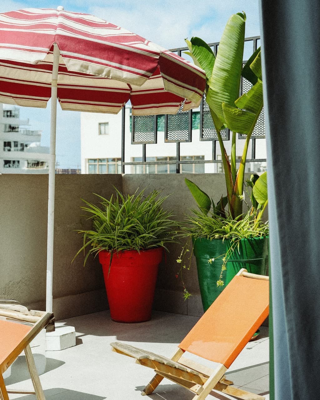 StayHere rooftop terrace with parasol and deck chairs