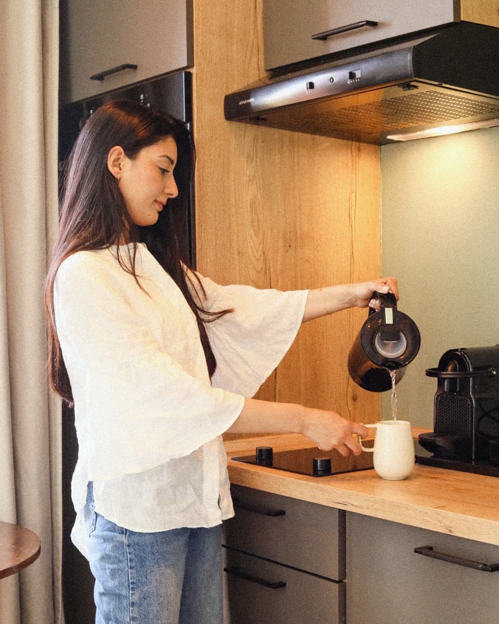 Guest making coffee in the StayHere kitchen